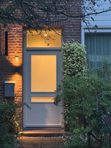 a gray door with a window on a brick house at Casa Galia Apartments in Nijmegen