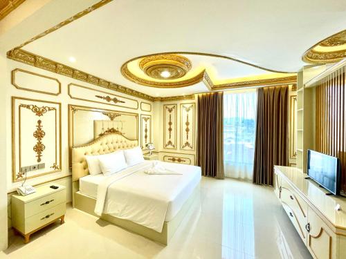 a bedroom with a white bed and a television at Atiyan Hotel Syariah in Bukittinggi