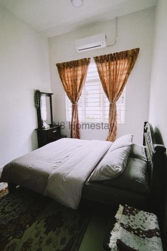 Ένα ή περισσότερα κρεβάτια σε δωμάτιο στο N8 Homestay, Arau