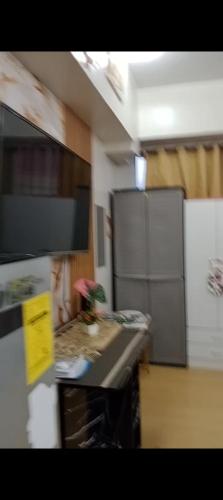 a kitchen with a counter top with a plant on it at Sweet Stay at Manila in Manila