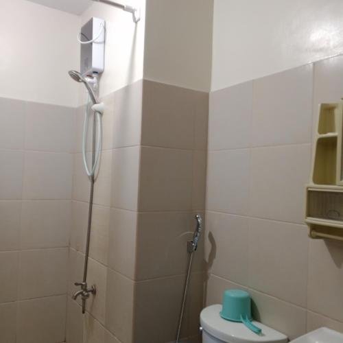 a bathroom with a shower and a toilet at Sweet Stay at Manila in Manila