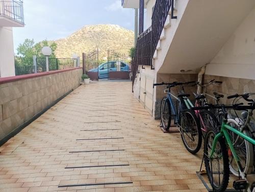 a group of bikes parked next to a building at PignaRossa Appartamenti in Mongiove