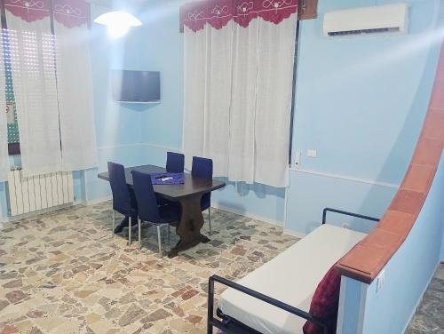 a room with a table and chairs and a bed at PignaRossa Appartamenti in Mongiove