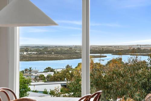 a view of a river from a dining room window at Tyntynder Coastal Beach House with Panoramic Views and Stunning Sunsets in Ocean Grove