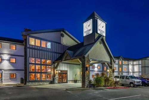 a building with a clock tower on top of it at Kathryn Riverfront Inn, an Ascend Collection Hotel in Seaside