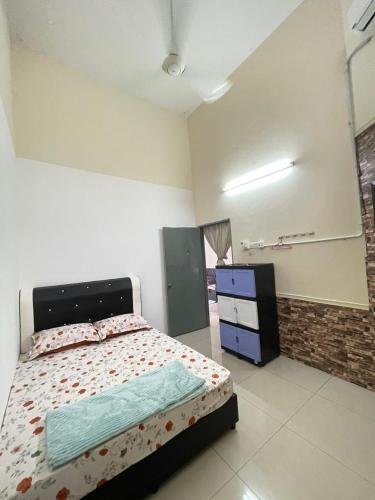 a bedroom with a bed and a dresser in it at D'sofia Homestay Jelebu 4 in Kuala Kelawang