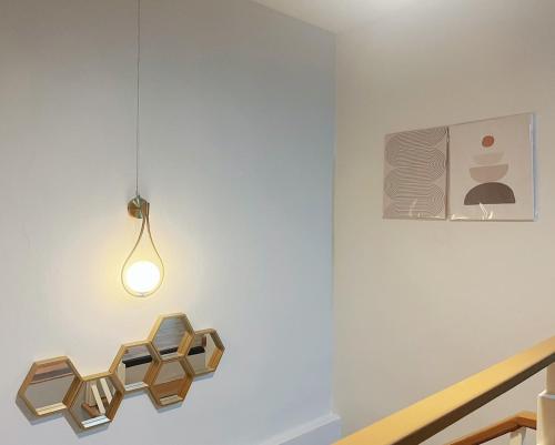 a light fixture hanging from a wall in a room at DeliZia de Villa Satun พักได้ 9 ท่าน in Satun
