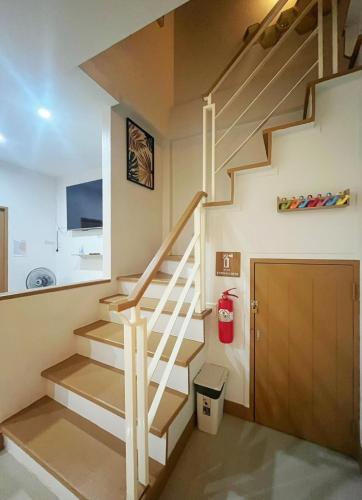 a staircase in a house with a trash can at DeliZia de Villa Satun พักได้ 9 ท่าน in Satun