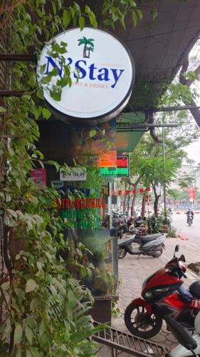 a sign for a shop with motorcycles parked on a street at N'stay - Netfix Stay room- Cafe Film Netflix - Bar cafe & drinks 2424 in Hanoi