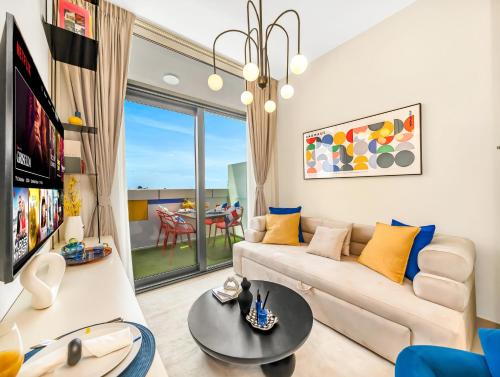 a living room with a couch and a table at Modern High-Floor Apartment with Burj Khalifa View by Dejaview Stays in Dubai