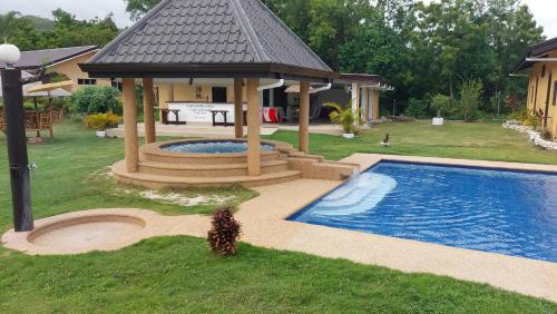 a gazebo with a swimming pool in a yard at Seaview Moonrise Café in Alcoy