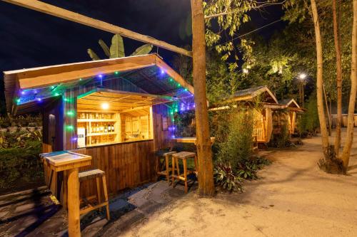 a small bar with lights on it at night at Nsaho resort in Fort Portal