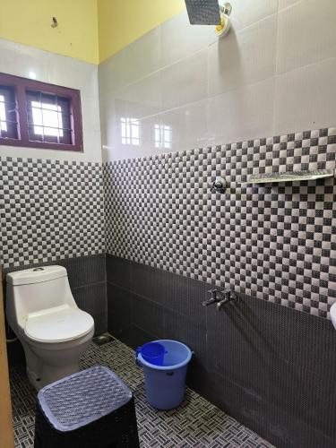 a bathroom with a toilet and a sink and a shower at Namasthe Ayurveda and Yoga Retreat Cochin in Nedumbassery