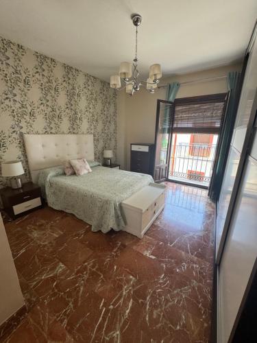 a bedroom with a bed with a marble floor at EL NIDO in Montoro