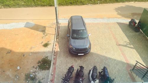 an overhead view of a car parked in a parking lot at Nature Inn With Greenery Comforts in Devanahalli-Bangalore