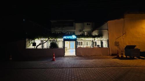 an empty street at night with a sign on a building at Akapella in Pamukkale