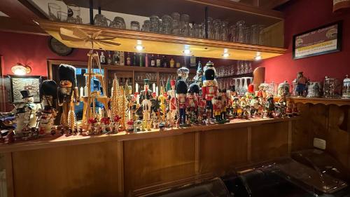 a bar with a lot of different types of bottles at Waldhotel Zöbischhaus in Bad Reiboldsgrün
