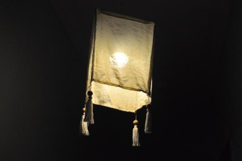 a lit up lamp with a white curtain on it at Backpackers in Sharm El Sheikh