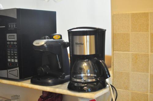 a coffee maker on a counter next to a microwave at Backpackers in Sharm El Sheikh