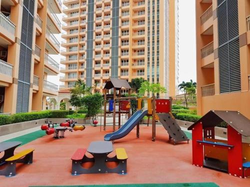 a playground in a building with a slide and play equipment at Luxury Bohemian Suite Venice Canal Mall & BGC Views in Manila
