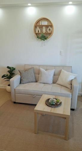 a living room with a couch and a table at Luxury Bohemian Suite Venice Canal Mall & BGC Views in Manila