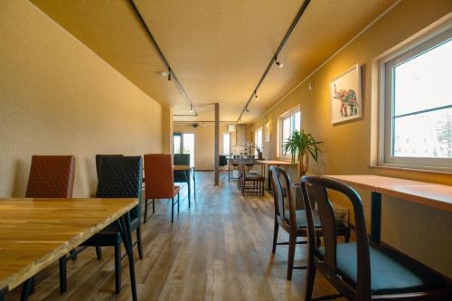 a dining room with tables and chairs and a window at TrainLineField in Tōbetsu