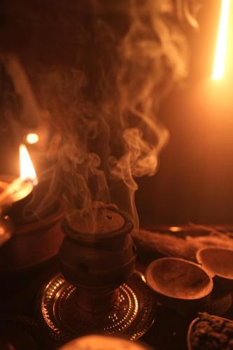 a close up of a candle and smoke at Namasthe Ayurveda and Yoga Retreat Cochin in Nedumbassery