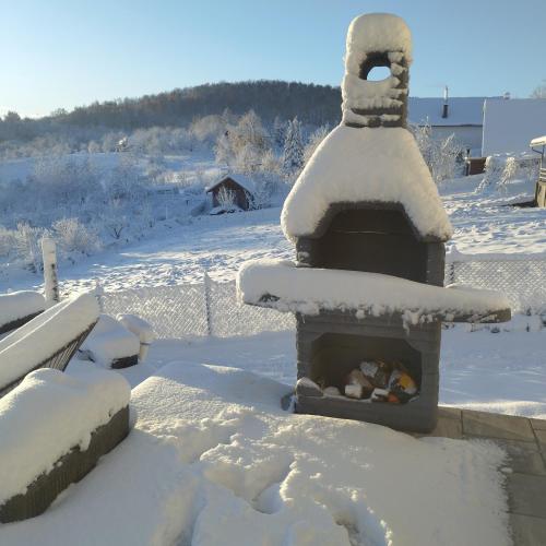 a snow covered oven with food inside of it at Casa Rado in Banja Luka