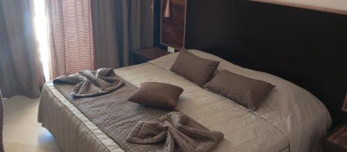 a bedroom with a bed with towels on it at Sahara Douz in Douz