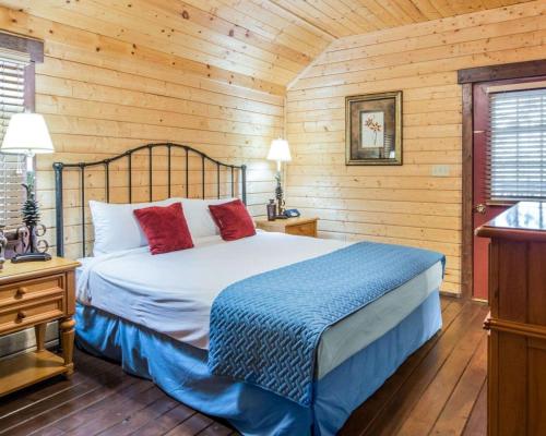a bedroom with a bed in a wooden cabin at Bluegreen Vacations Shenandoah Crossing, an Ascend Collection Resort in Gordonsville