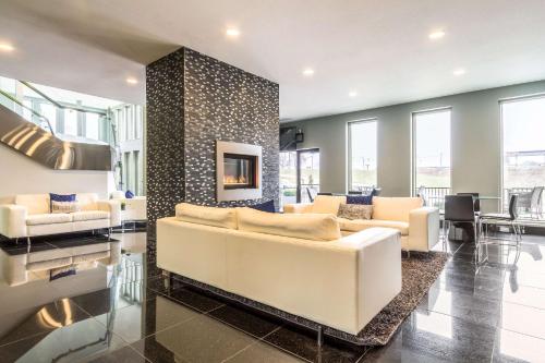 a living room with a white couch and a fireplace at The Wallhouse Hotel, an Ascend Collection Hotel in Walnut Creek