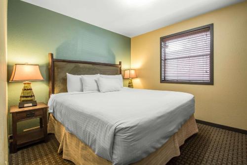 a bedroom with a large bed and a window at Bluegreen Vacations Christmas Mountain Village, an Ascend Collection Resort in Wisconsin Dells