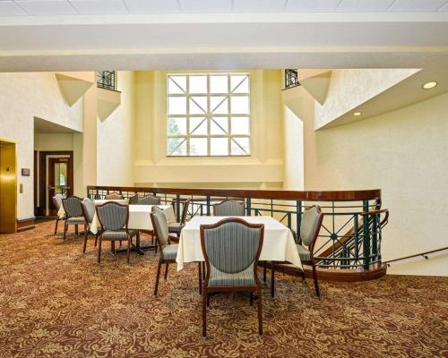 a conference room with tables and chairs and a window at Kress Inn, an Ascend Collection Hotel in De Pere