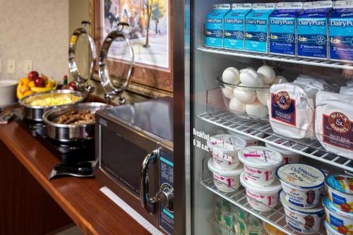 an open refrigerator filled with lots of food and drinks at Kress Inn, an Ascend Collection Hotel in De Pere