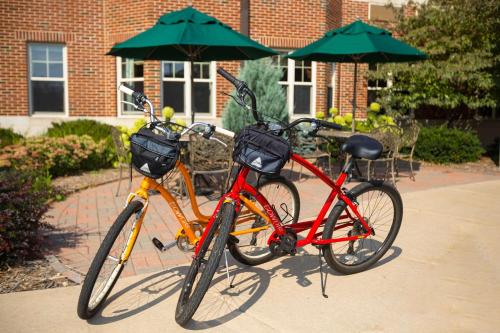 two bikes parked next to each other under an umbrella at Kress Inn, an Ascend Collection Hotel in De Pere