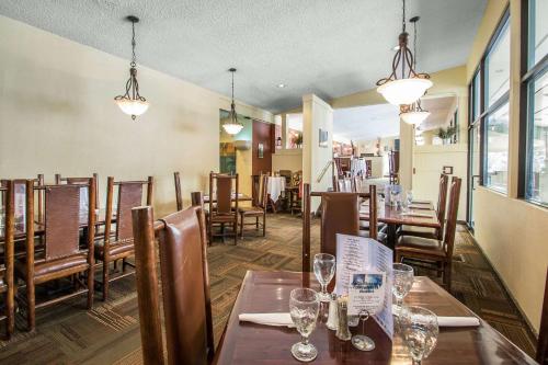 a restaurant with wooden tables and chairs and glasses at Bluegreen Vacations Christmas Mountain Village, an Ascend Collection Resort in Wisconsin Dells