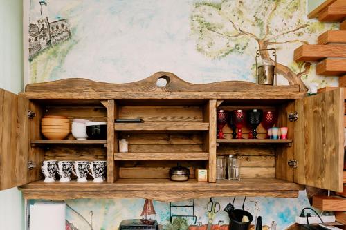 a wooden shelf on a wall with various items on it at Rakvere Vanalinna Apartment in Rakvere