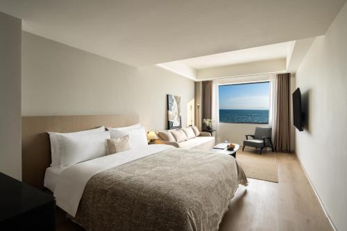 a hotel room with a bed and a living room at Shenzhen White House Seaview Resort Hotel in Shenzhen
