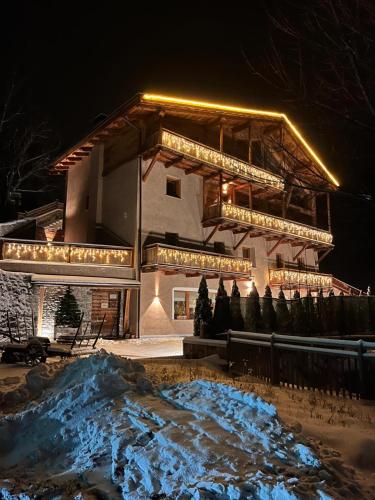 a building with lights on top of it at night at Grande Cote Room and Breakfast in Cesana Torinese