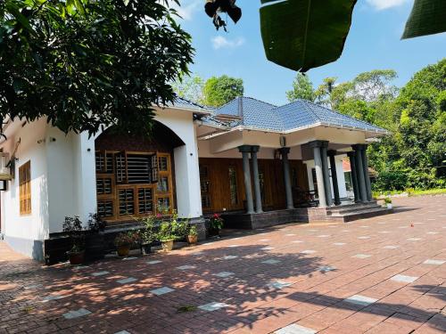 a house with a brick driveway in front of it at Entire Private Luxury Resort in Wayanad - Cinnamon Villa Wayanad in Panamaram