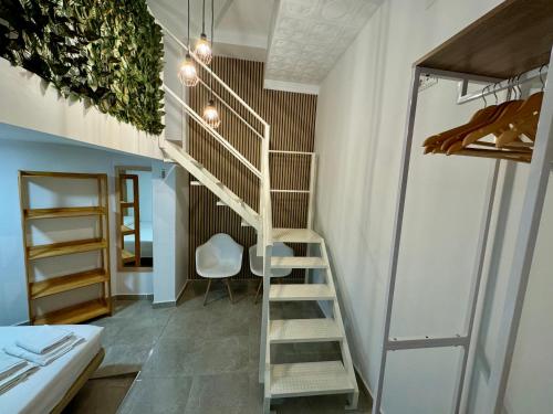 a spiral staircase in a room with a bed at Suite la Bella in Torre del Mar