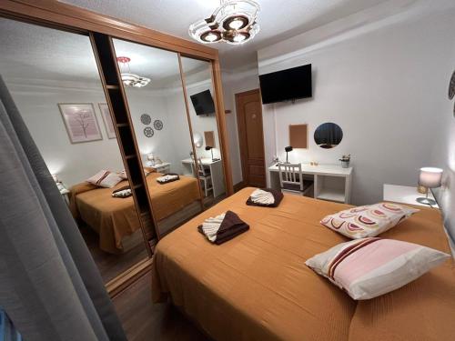 a hotel room with two beds and a mirror at Rooms Pontones in Madrid