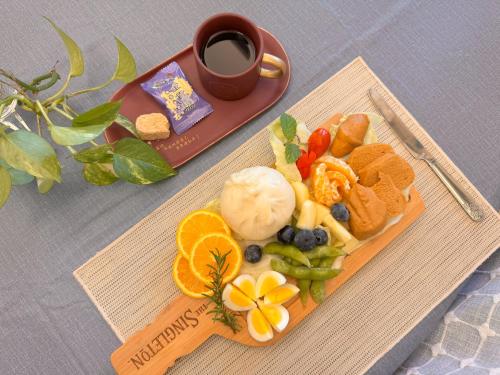 a plate of food on a table with a cup of coffee at Jin Dun Yuan in Jinning