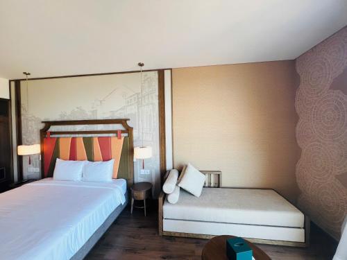 a hotel room with two beds and a table at Apec Mandala Cham Bay Condotel Mui Ne in Mui Ne
