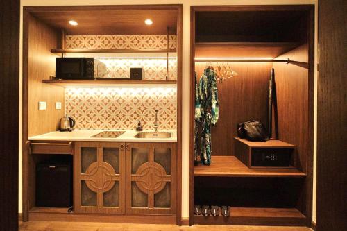 a kitchen with a sink and a microwave at Apec Mandala Cham Bay Condotel Mui Ne in Mui Ne