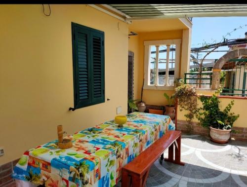 a room with a table and a bench and a window at VILLA ROSY LIDO di NOTO in Noto Marina