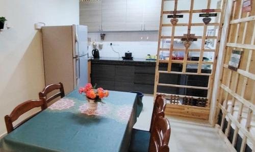 a kitchen with a blue table and a refrigerator at YUYU B2 Honeymoon WiFi Genting highland in Genting Highlands