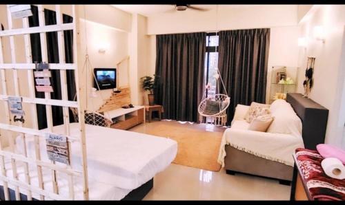 a living room with a white couch and a living room with at YUYU B2 Honeymoon WiFi Genting highland in Genting Highlands