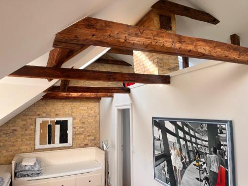 a room with wooden beams on the ceiling at Townhouse in Odense