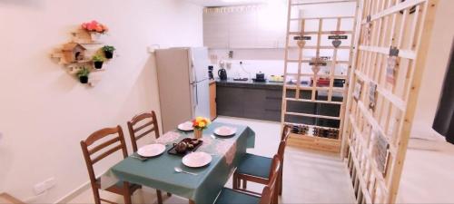 a kitchen with a table and chairs and a kitchen with a refrigerator at YUYU B2 Honeymoon WiFi Genting highland in Genting Highlands